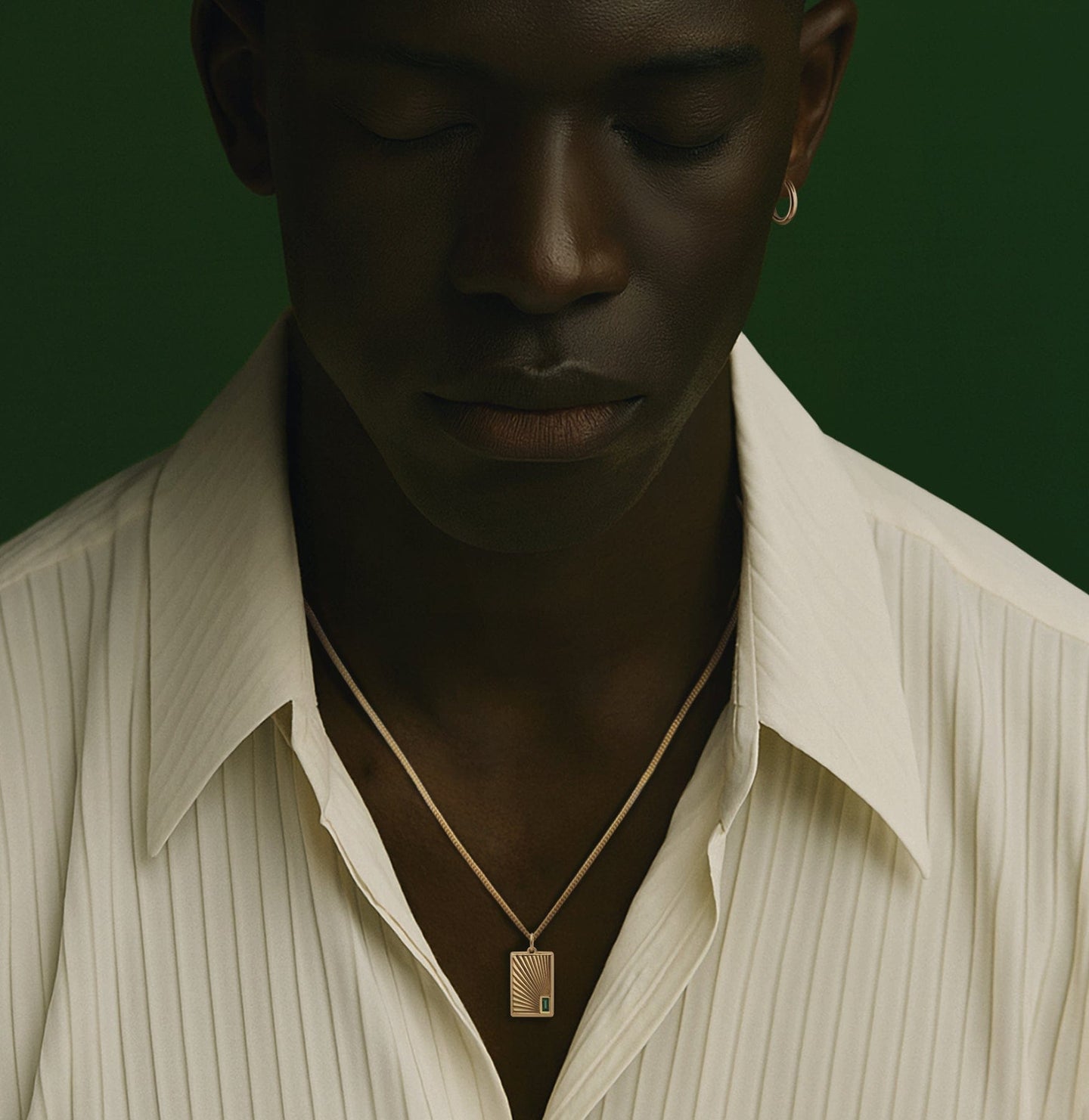 New Men's - Person wearing a necklace with a pendant against a dark background