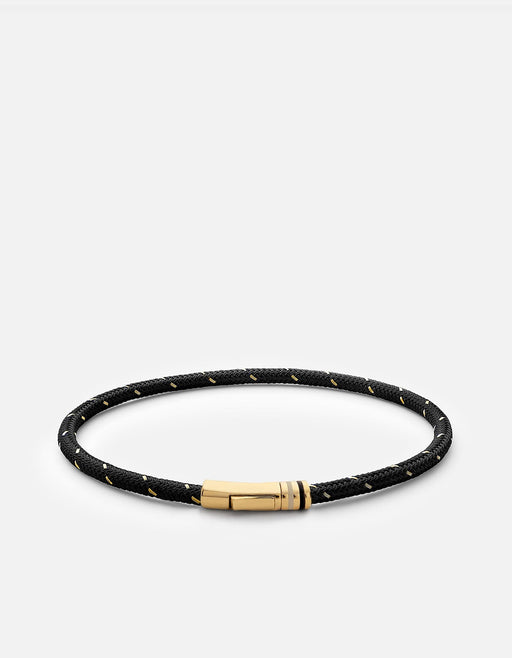 Miansai Juno rope bracelet in black nylon and steel with a gold vermeil spring clasp closure