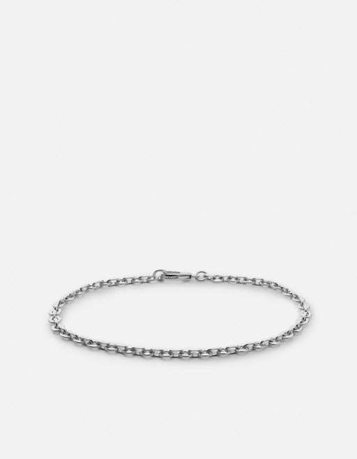 Miansai Rio chain bracelet in polished sterling silver with faceted oval links and a lobster clasp laid flat in an oval shape