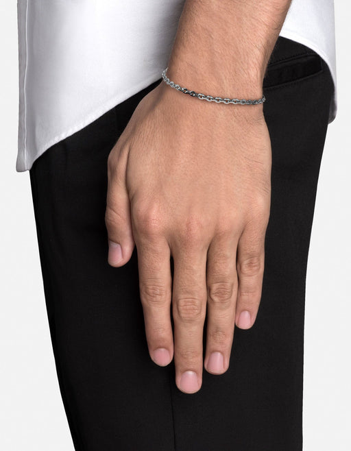 Miansai Rio chain bracelet in polished sterling silver worn on the wrist with faceted oval links