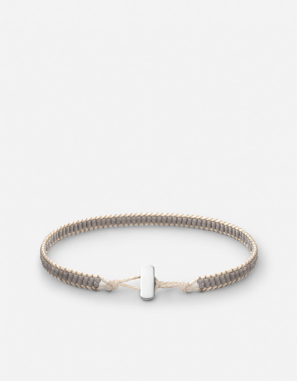 Miansai Lowe double bead bracelet in sterling silver with gray linen-toned beads woven on natural cord, laid flat with bar closure visible