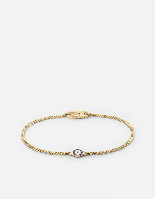 Miansai gold vermeil Cuban curb chain bracelet with a blue and white enamel evil eye centerpiece laid flat