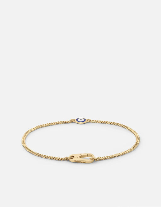 Miansai single evil eye chain bracelet in gold vermeil with a blue and white enamel eye and Cuban curb chain laid flat