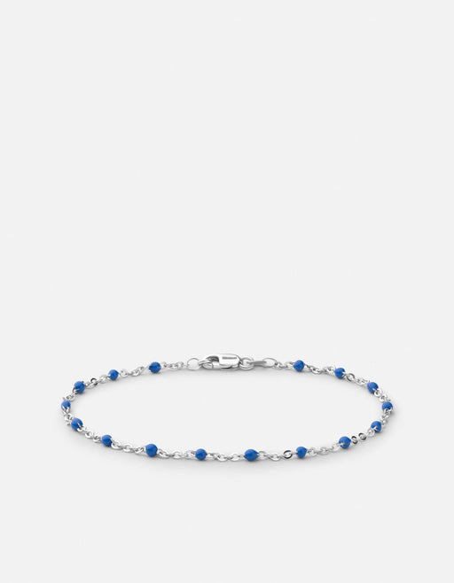 Miansai Ciro chain bracelet in polished sterling silver with blue enamel spheres set along the links laid flat