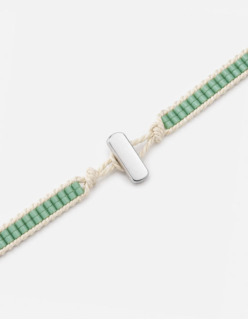 Miansai Lowe double bead bracelet in sterling silver with teal beads and cream cord showing the polished bar clasp