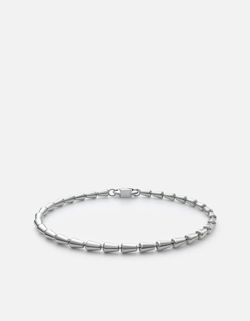 Miansai Elara chain bracelet in polished sterling silver with alternating tapered bead links and a custom clasp, laid flat