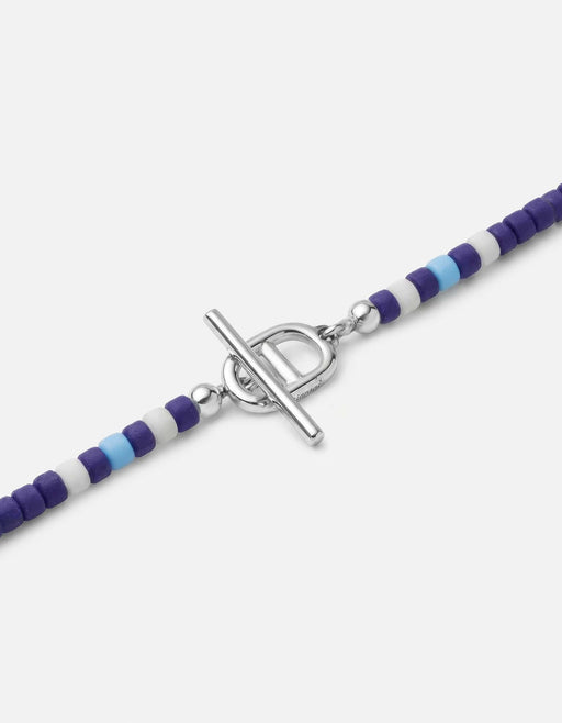 Miansai Avi bead bracelet in sterling silver with deep blue heishi beads and a striped section beside the toggle closure