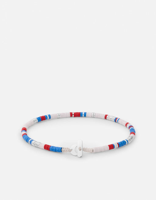 Miansai Cove bead bracelet in sterling silver with red white and blue heishi beads in color-block sections and a silver clasp laid flat