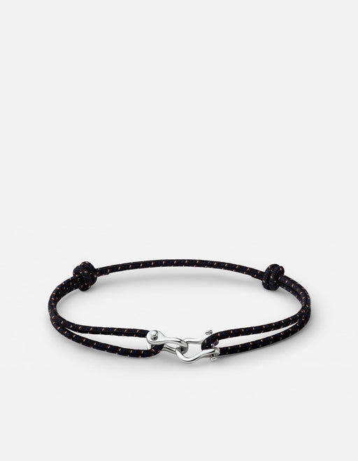 Miansai black bungee bracelet with brown tracers and a polished silver-tone screw cuff laid flat