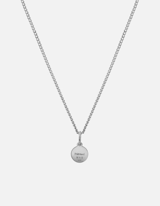 Miansai Ojos necklace in sterling silver with a fine chain and circular reverse pendant bearing engraved branding