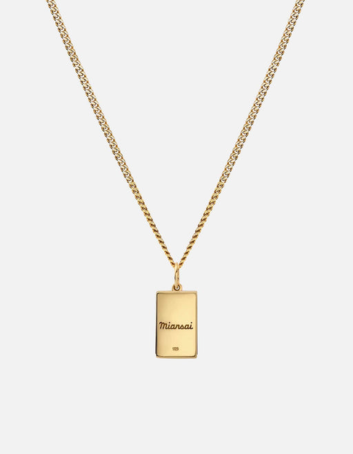 Miansai gold vermeil pendant necklace with a rectangular bar pendant featuring an engraved logo on a fine chain