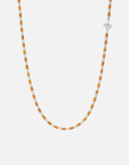 Miansai Kai carnelian bead necklace in alternating soft orange and white with a sterling silver T bar clasp in a U shaped drape
