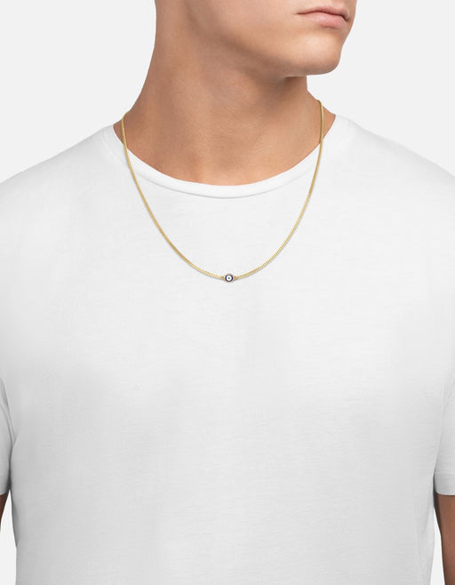 Miansai gold vermeil Cuban chain necklace with a small blue and white enamel evil eye pendant worn at the neck