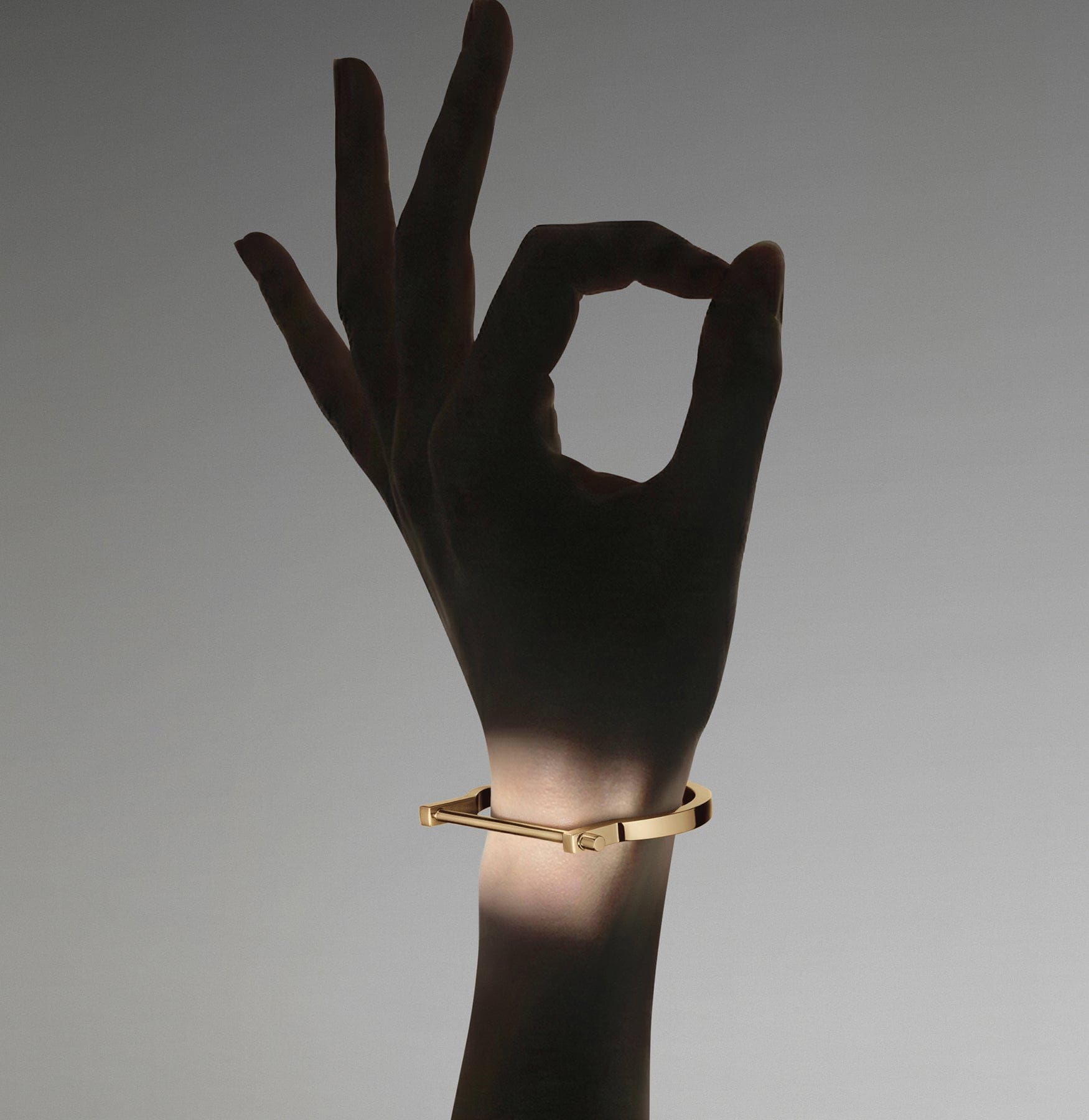 Woman wearing modern screw cuff.
