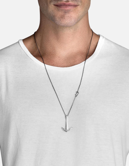 Miansai anchor pendant necklace in oxidized sterling silver worn at the neck with a polished anchor and front shackle detail