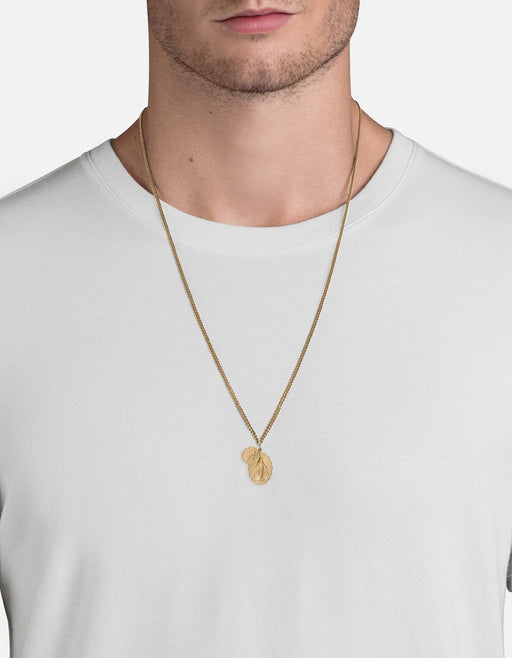 Miansai Mini Saints pendant necklace in matte 14k gold worn at the neck with scalloped Marian and Saint Christopher medallions