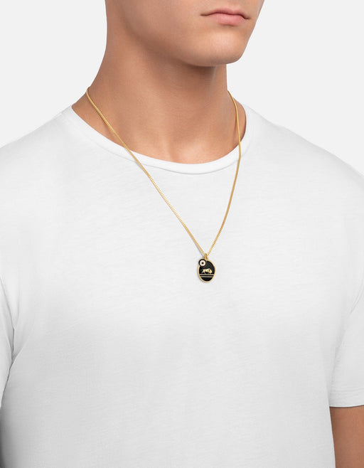 Miansai Oxen pendant necklace in gold vermeil with an oval black enamel medallion and gold ox motif, worn on a fine chain at the chest