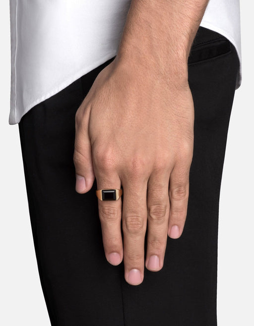 Miansai Lennox onyx ring in 14k gold worn on the hand with its rectangular black stone visible