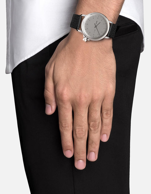 Miansai M12 Swiss watch in stainless steel with a silver dial and black Italian leather strap worn on the wrist