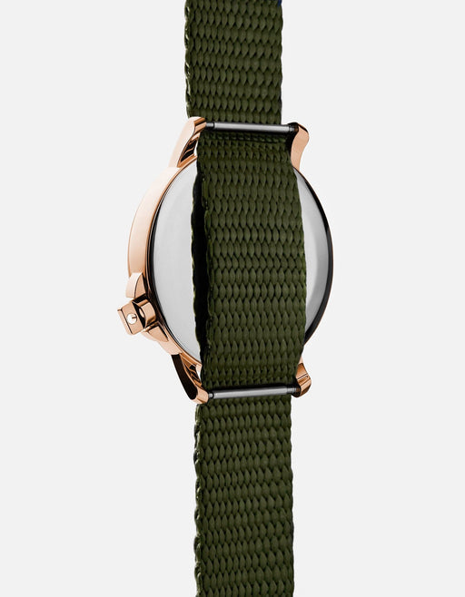 Miansai M12 Swiss watch with rose tone stainless steel case and hunter green climbing webbing nylon strap shown from the back