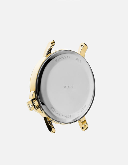 Miansai M12 Swiss watch with gold tone stainless steel caseback and exposed lugs showing Swiss Made and 3 ATM markings