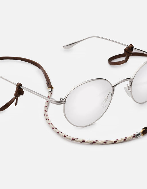 Miansai Nexus sunglass cord in brown Italian leather and patterned nylon rope with sterling silver finishes attached to round silver sunglasses